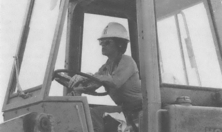 Photo of woman driving a bulldozer or other piece of construction equipment
