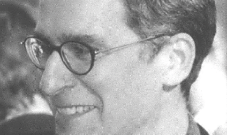 Side profile portrait of smiling man in glasses