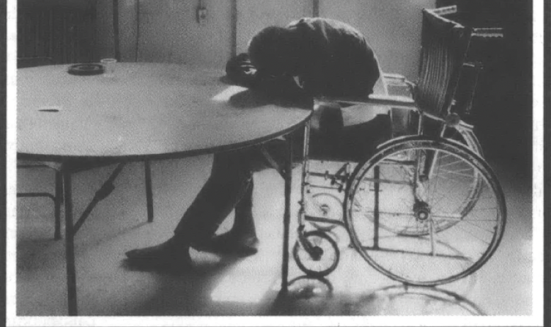 Man in wheelchair slumped over a table. Caption reads "The lack of alternatives condemns many elderly to institutions."