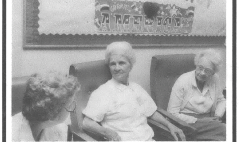 Three elderly women seated and talking