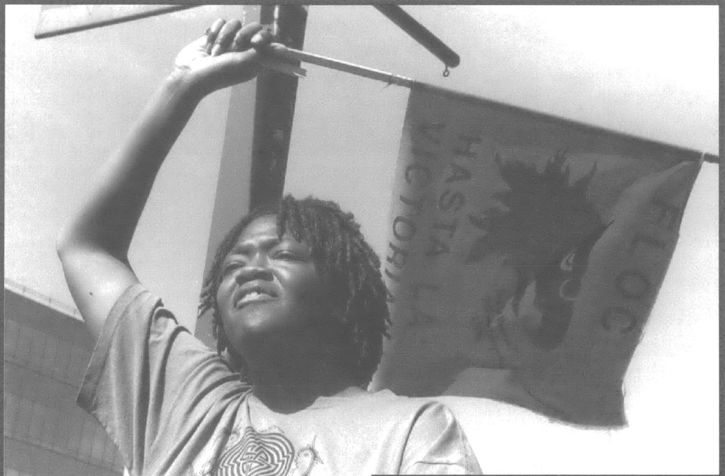 Black woman waving small flag