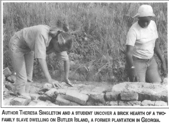 Two women, one white and one Black, working in an archaeological dig