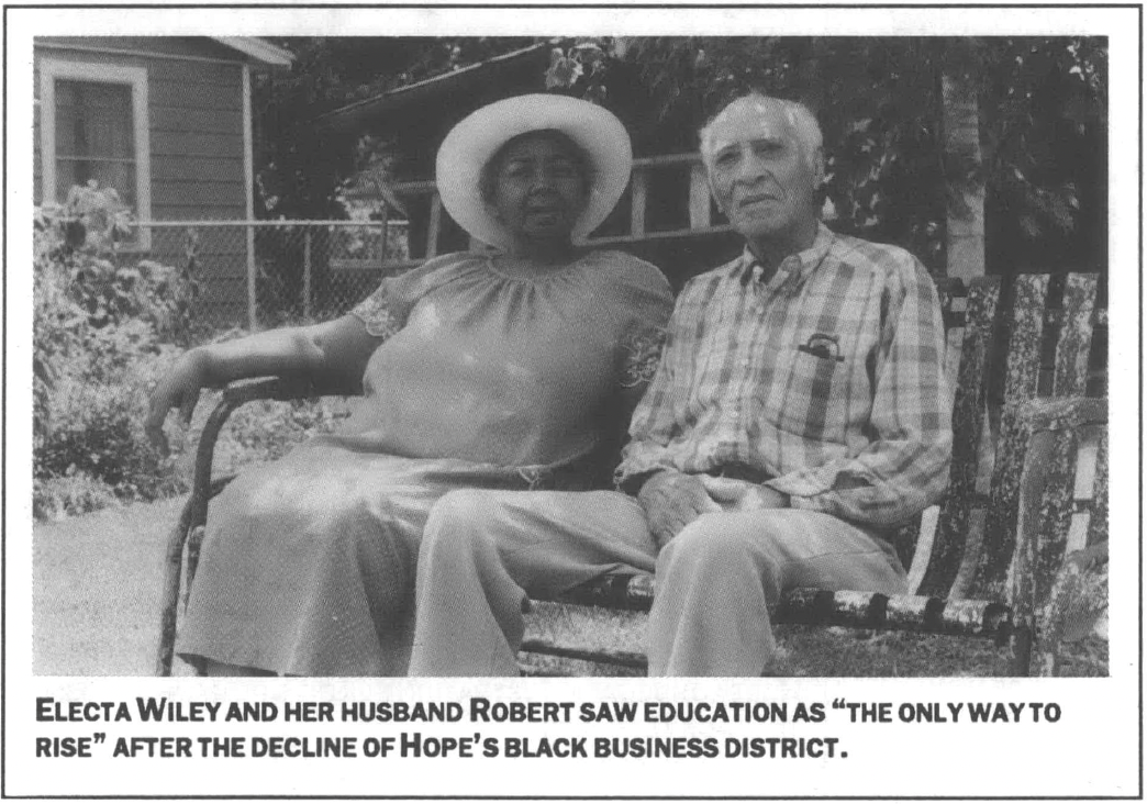 photograph portrait of a man and woman sit on a rocking bench in a backyard 