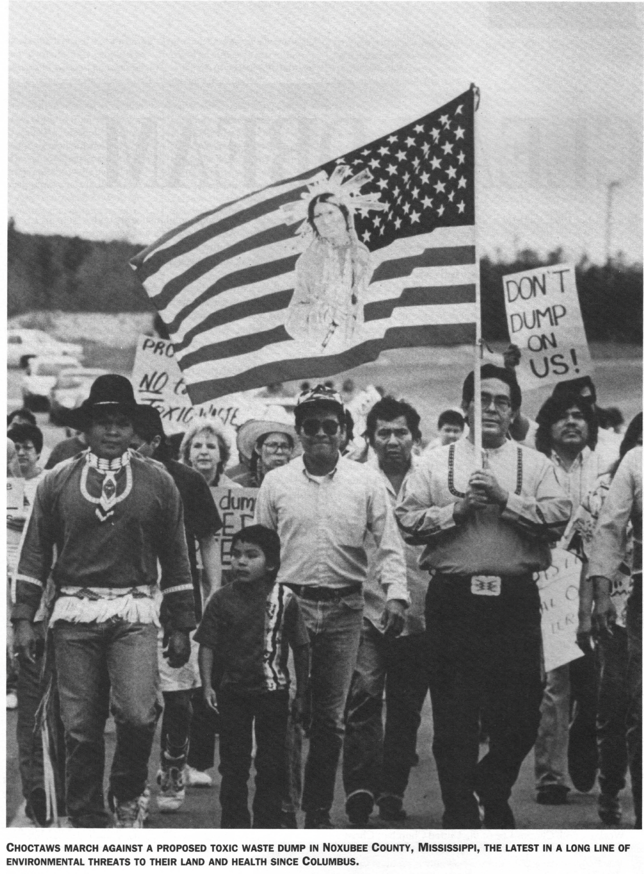 Black and white photo of group of marchers, mostly people of color