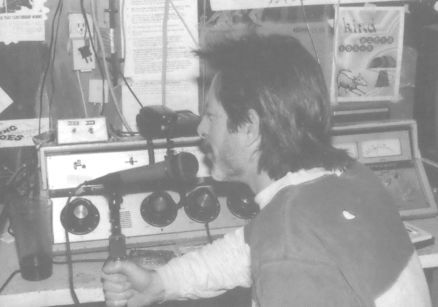 Man with mullet talking into a radio microphone