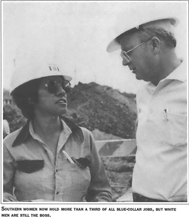 a woman and a man in hard hats talking to each other
