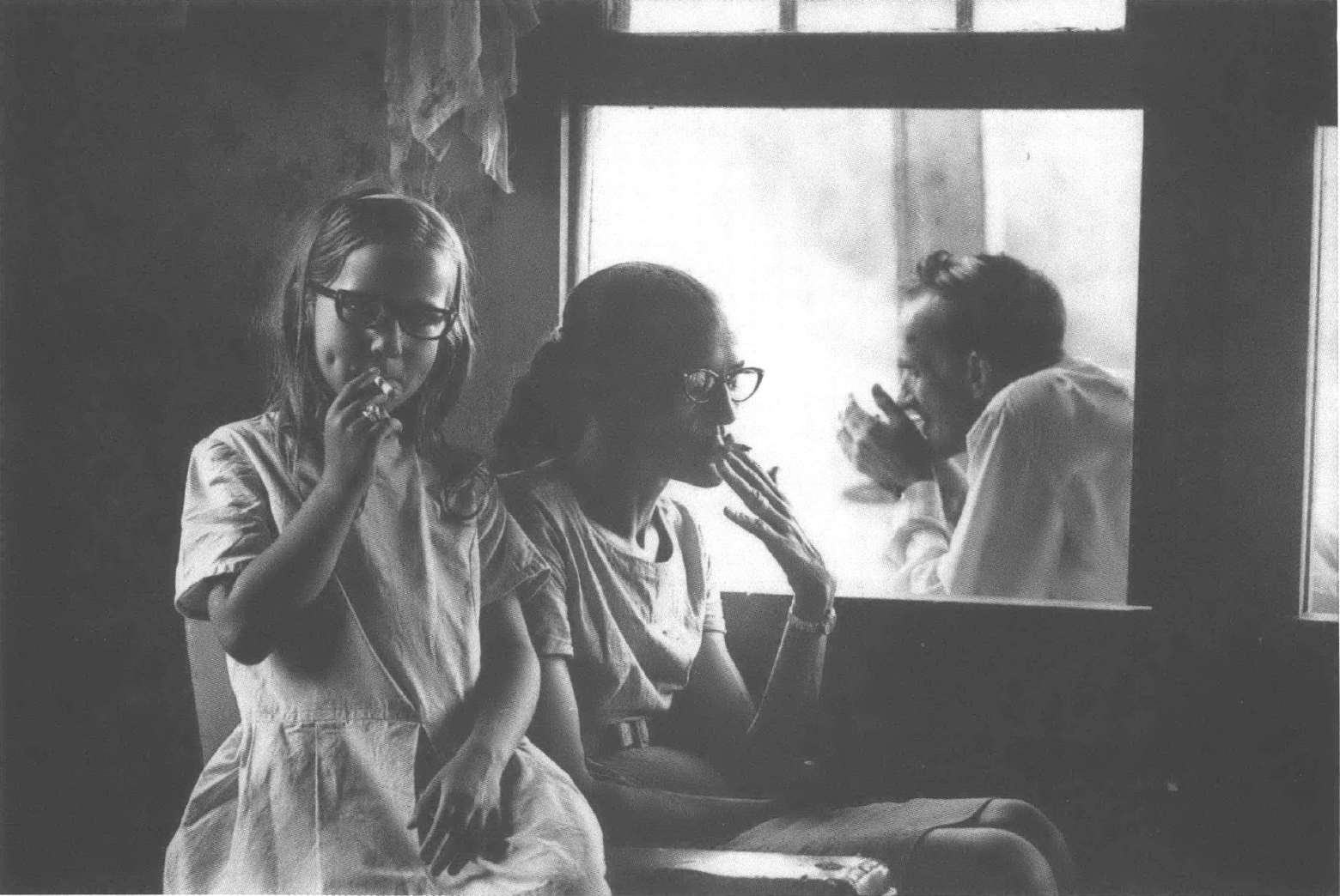 Family, including child, all smoking cigarettes
