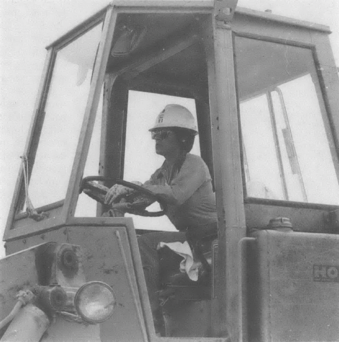 Photo of woman driving a bulldozer or other piece of construction equipment