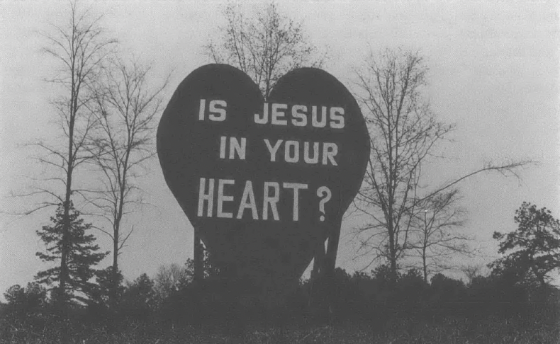 Photo of large heart on the side of the road that reads "Is Jesus In Your Heart?"