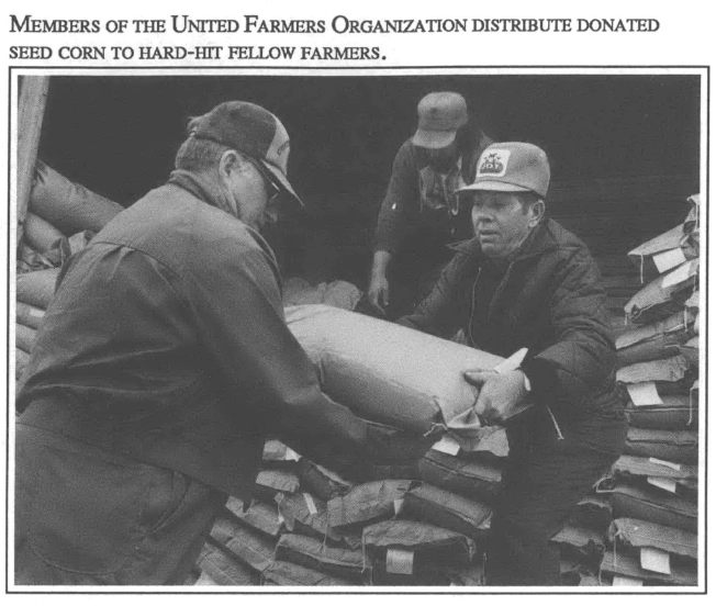 Members of the United Farm Organization distribute donated seed corn to hard-hit fellow farmers