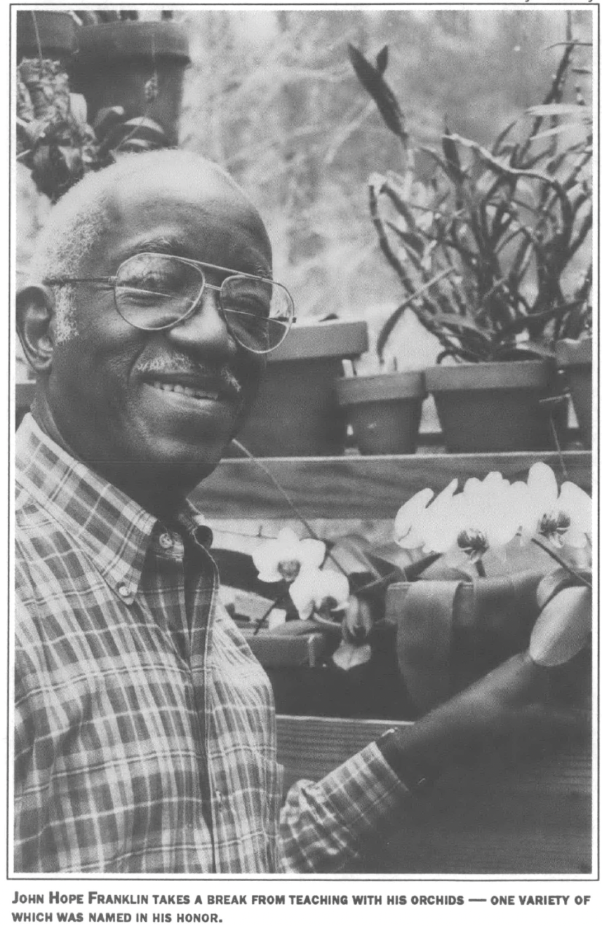 John Hope Franklin posing with orchids