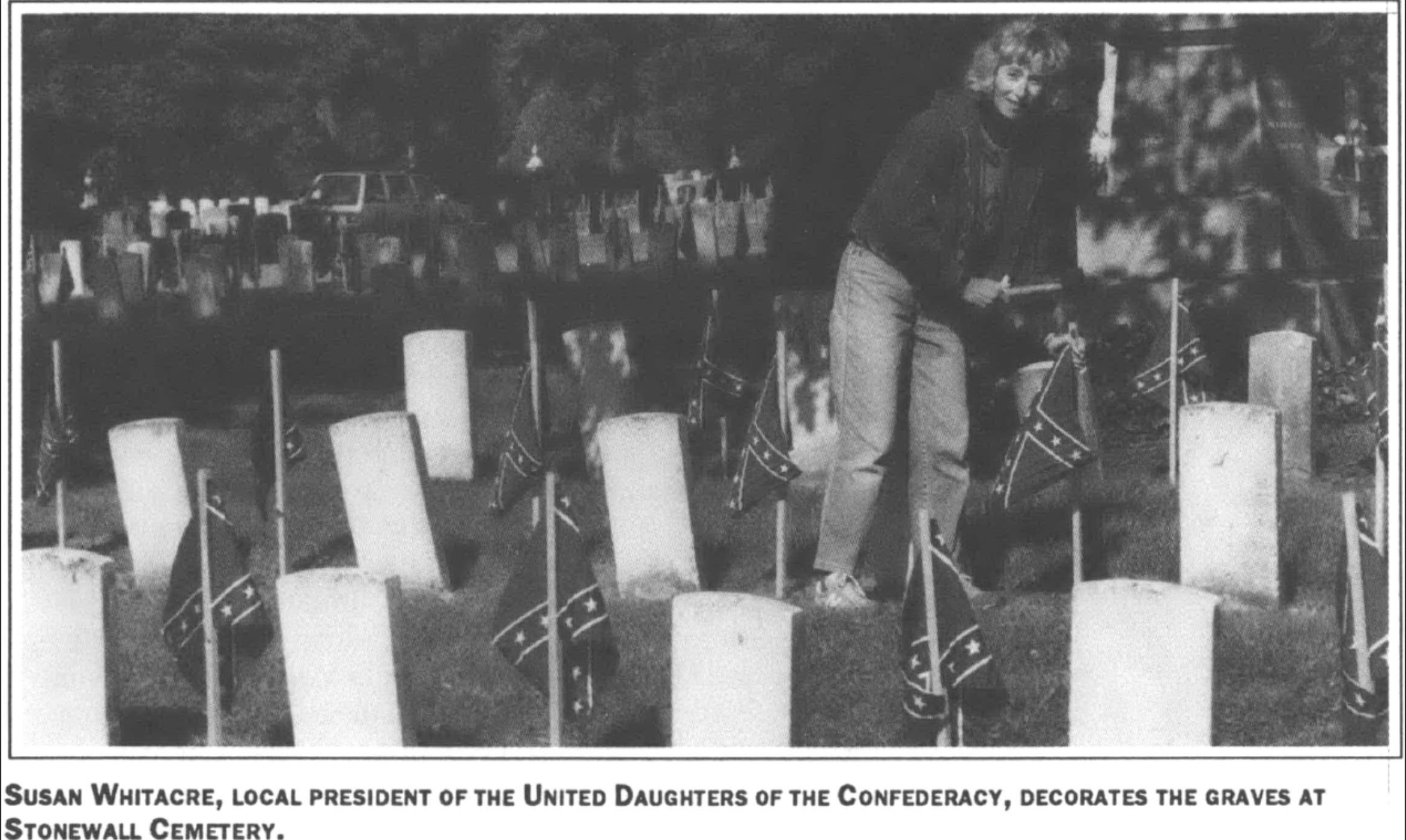 woman decorating graves with Confederate flags