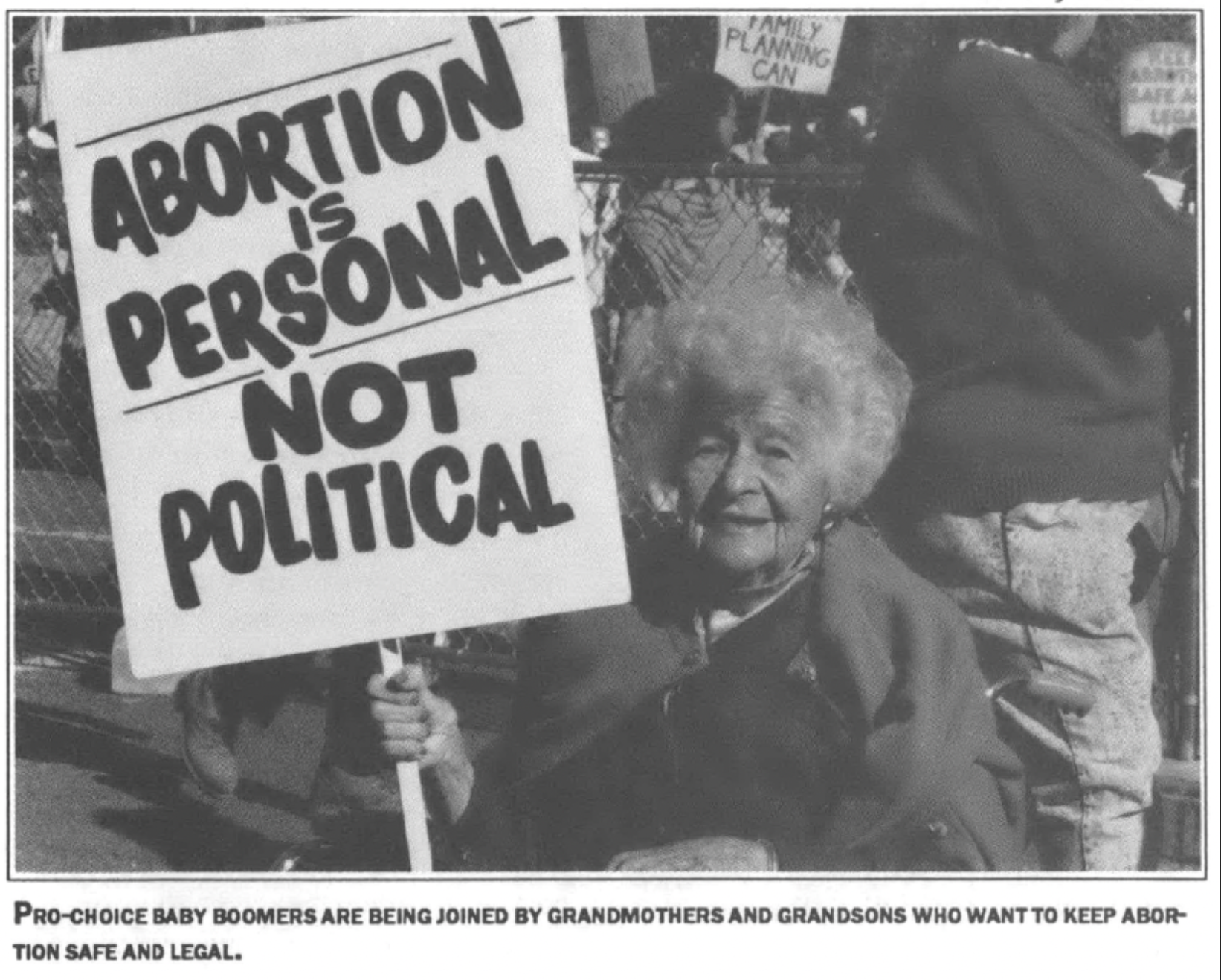 woman holding sign reading "Abortion is personal, not political"