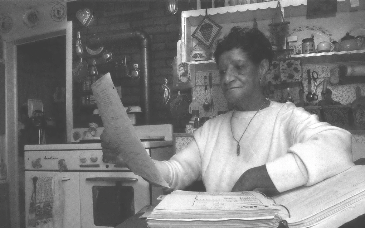 Woman reviews documents in her kitchen