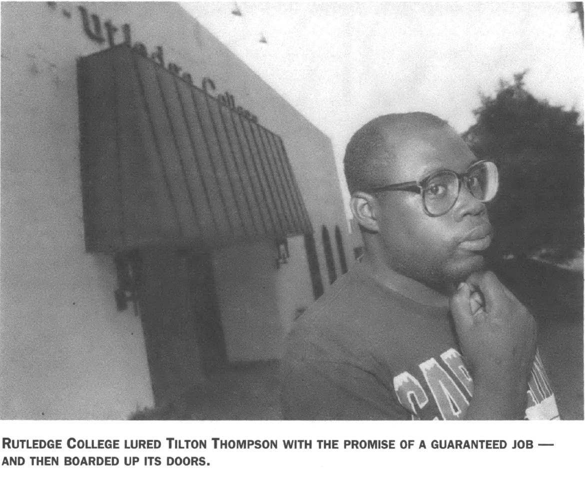 Black man with glasses and hand on chin posing in front of office building