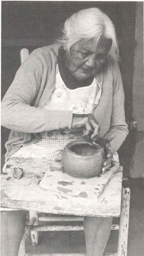 Old woman working a clay pot